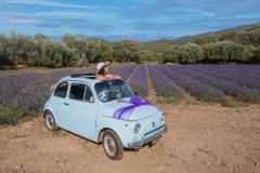girl in walks in a field of lavender. View from the back