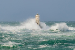 Powerful waves crashing against a Mangiabarche lighthouse during a hurricane, symbolizing resilience and the forces of nature